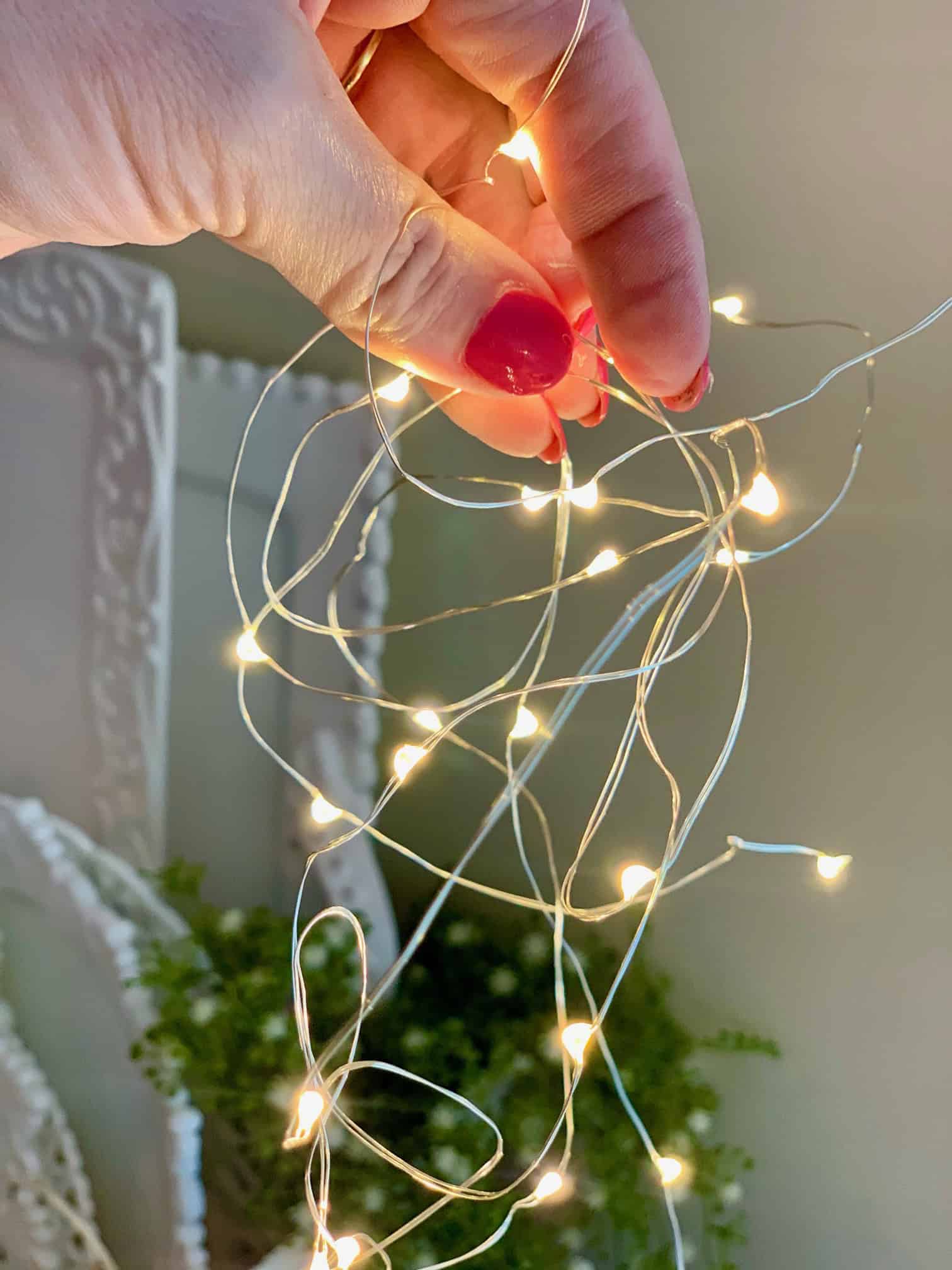 Holding twinkle lights while they fall.