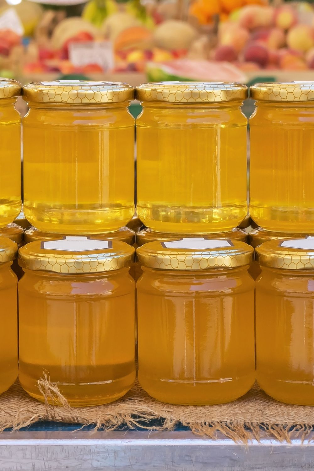 A line of jars filled with herb infused honey ready to be placed in storage. 