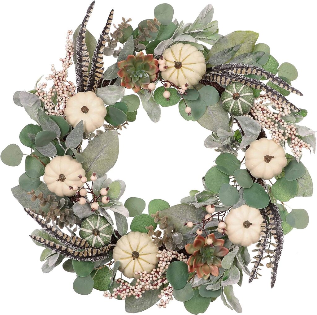 gorgeous eucalyptus wreath with feathers, white mini pumpkins, berries, gords and succulents. 