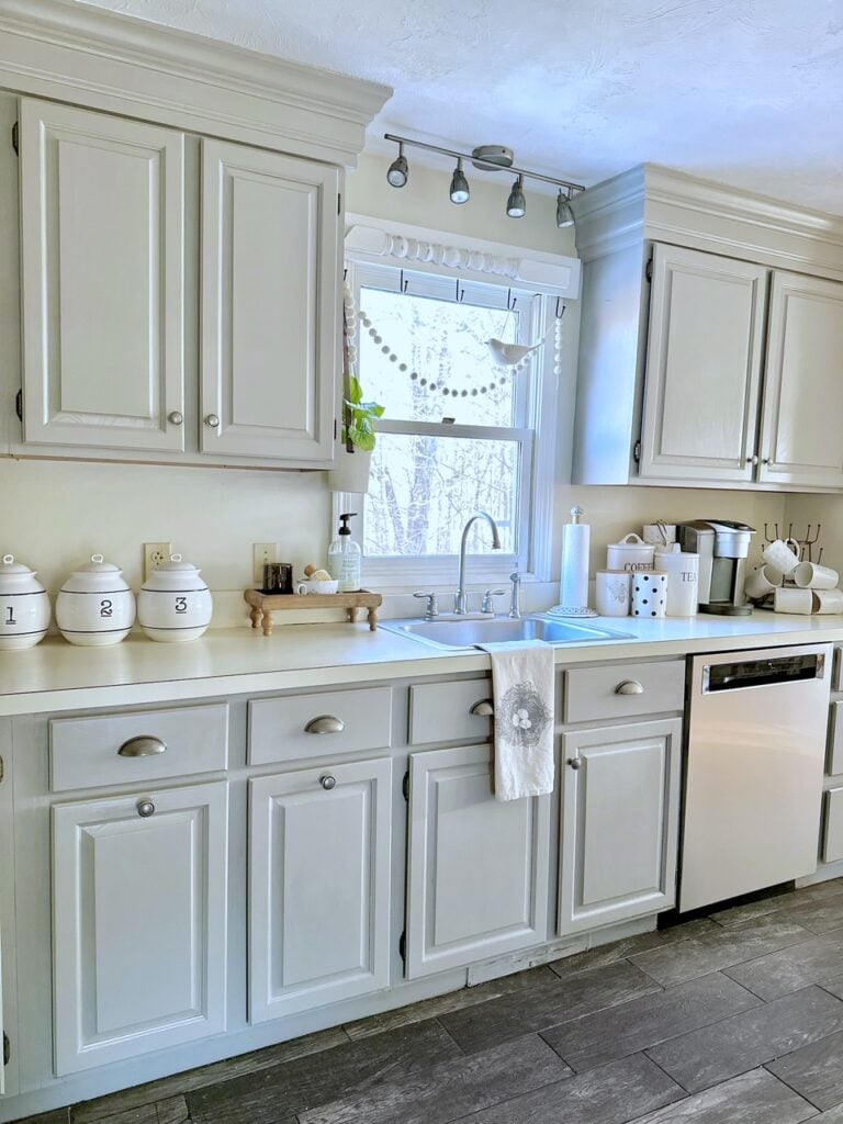 The after picture with light gray kitchen cabinets. the space is light and bright.