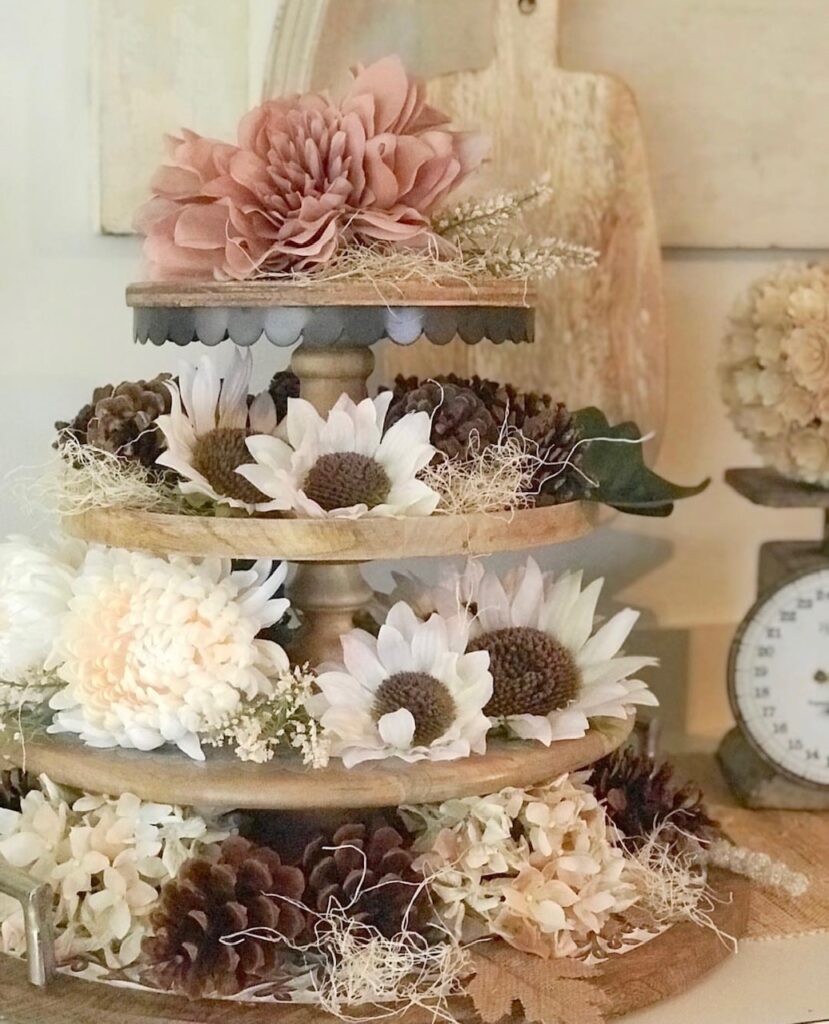 a fall collection of faux flowers, excelsior, pinecones. in mauve, cream tones and browns. 
