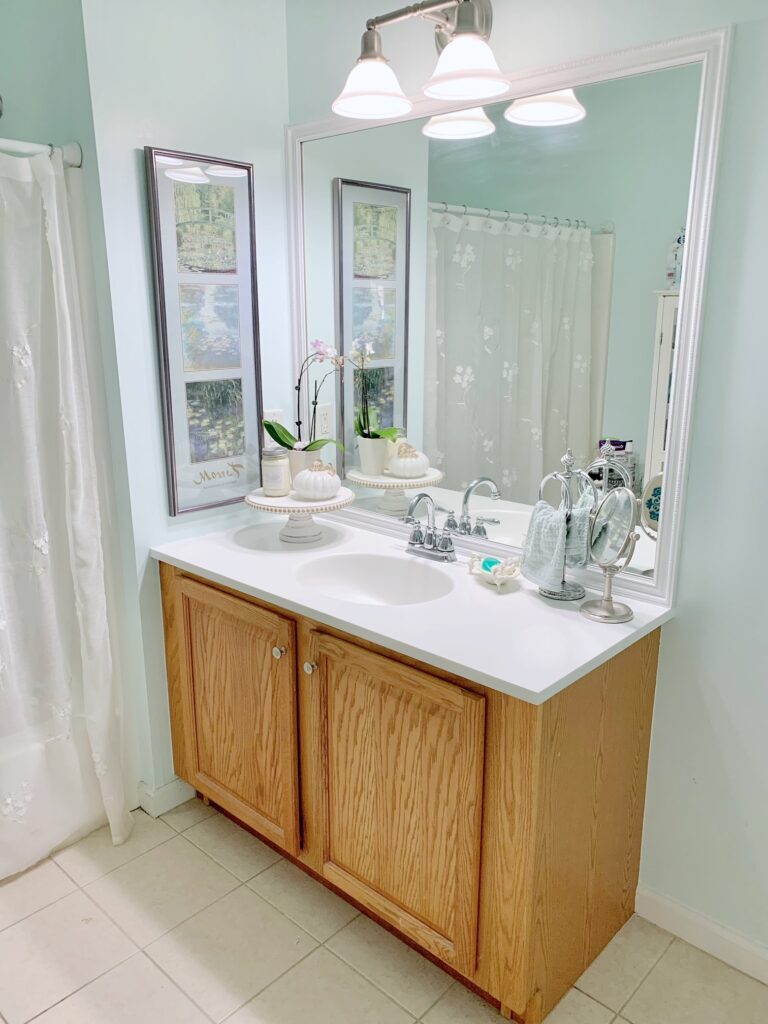 completed project! the mirror is shown sitting over an oak bathroom vanity with white top. 