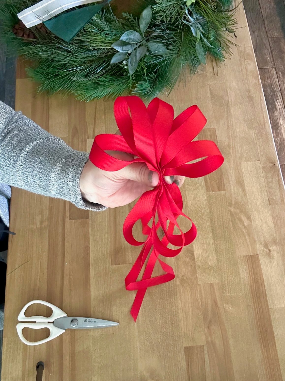 The last bow which is red and smaller ribbon.