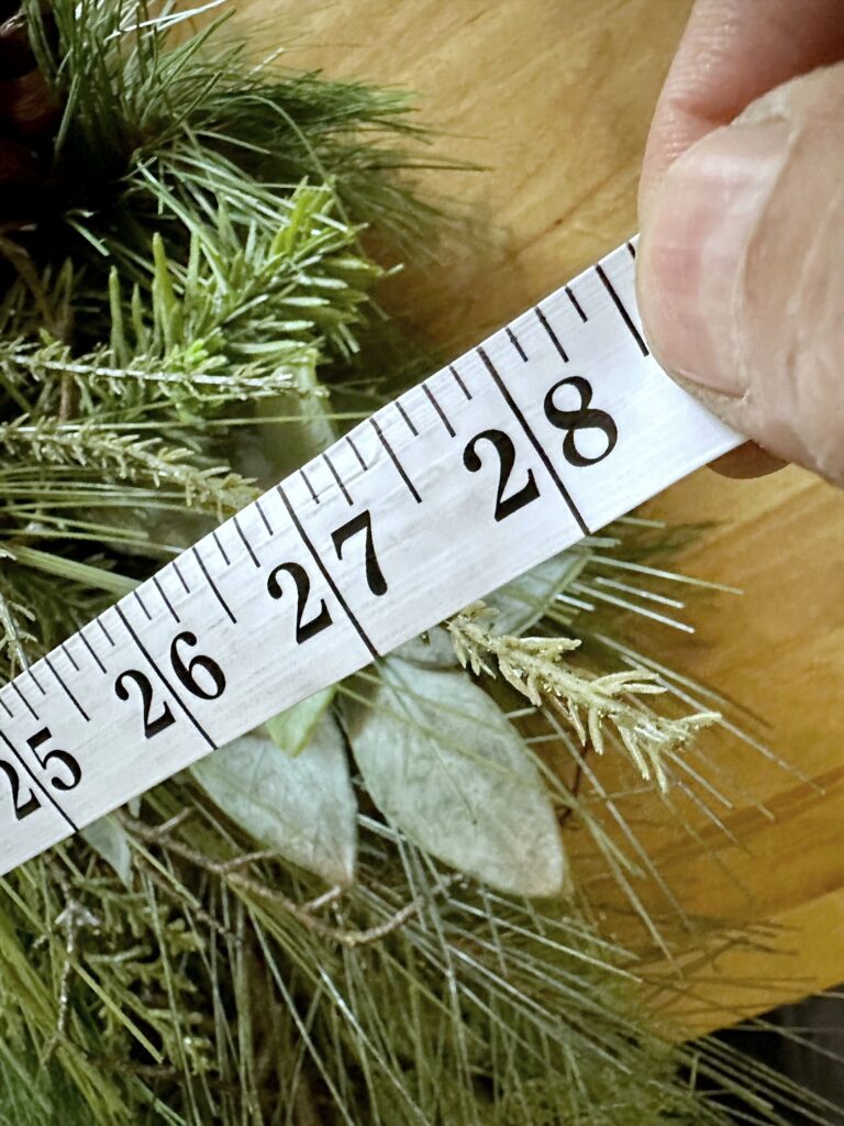 Tape measure indicating the wreath is 28' wide. 