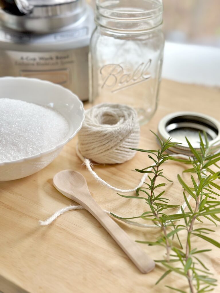 supplies -  rosemary, salt, twine, spoon, jar and cover, food processor. 