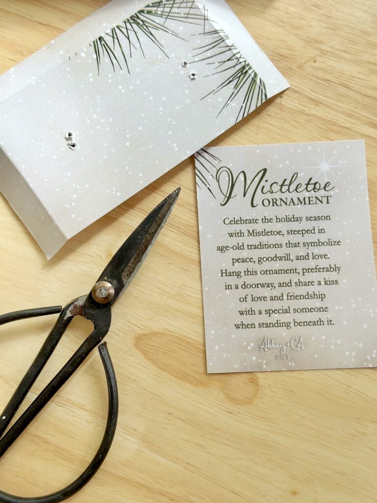 scissor showing the sentiment cut out to create a gift tag. 