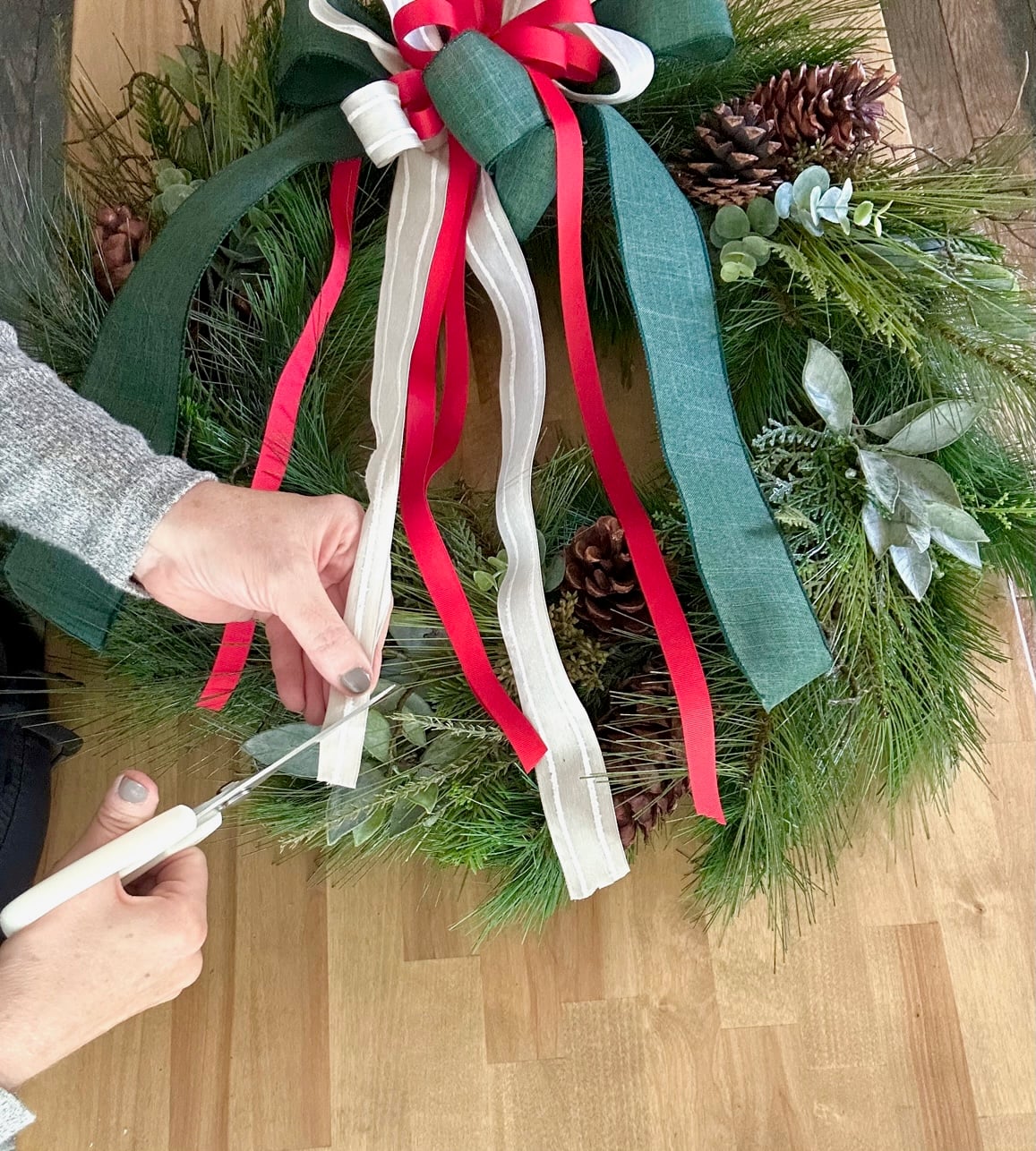 Cutting the ends of the ribbon of the layered bow.