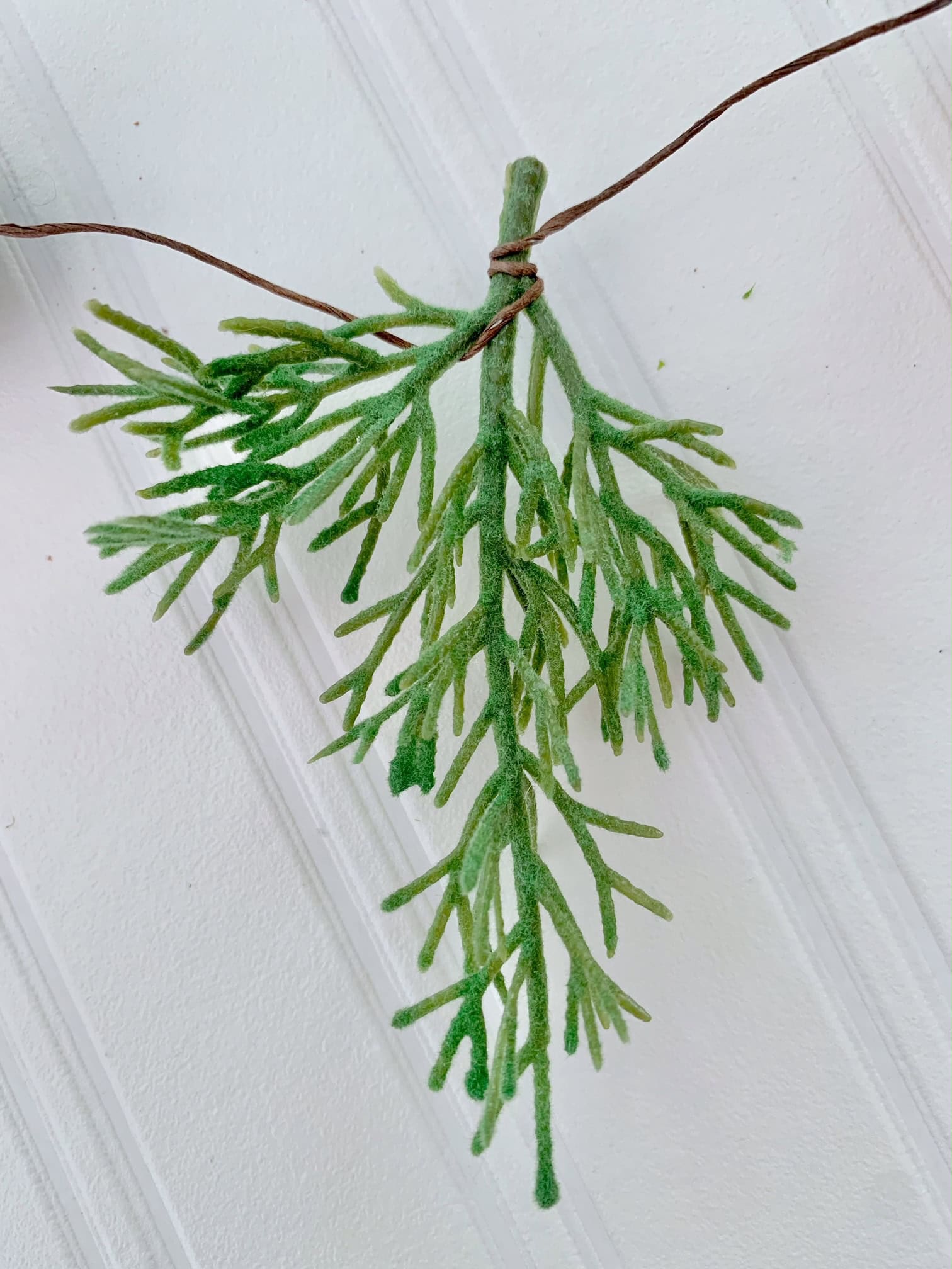 A small stem of faux greens.