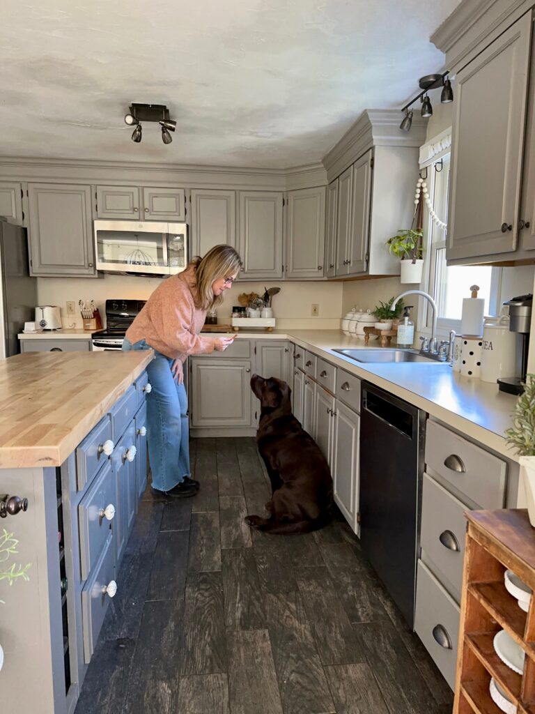 me giving our chocolate lab, Allie a treat in between our island and counters. 
