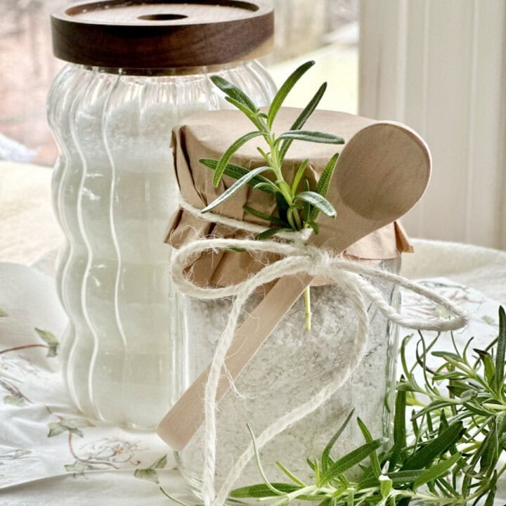 Rosemary salt in a jar with a larger jar of salt.
