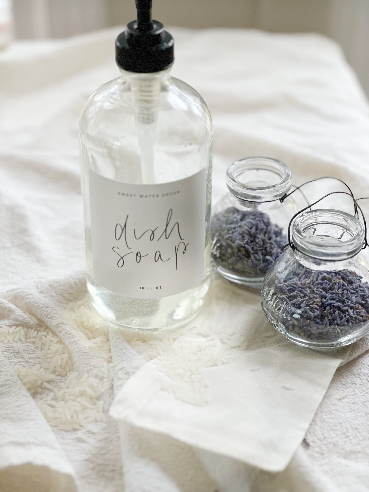 Dish soap with glass jars of lavender.