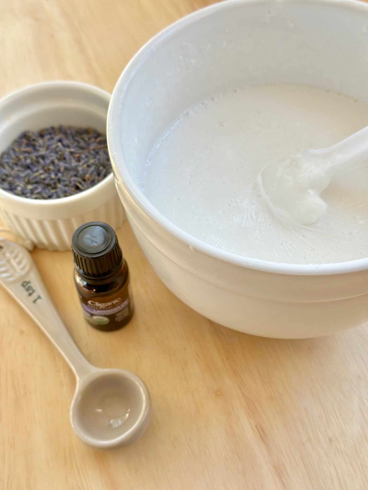 melted goats milk soap in a white bowl.