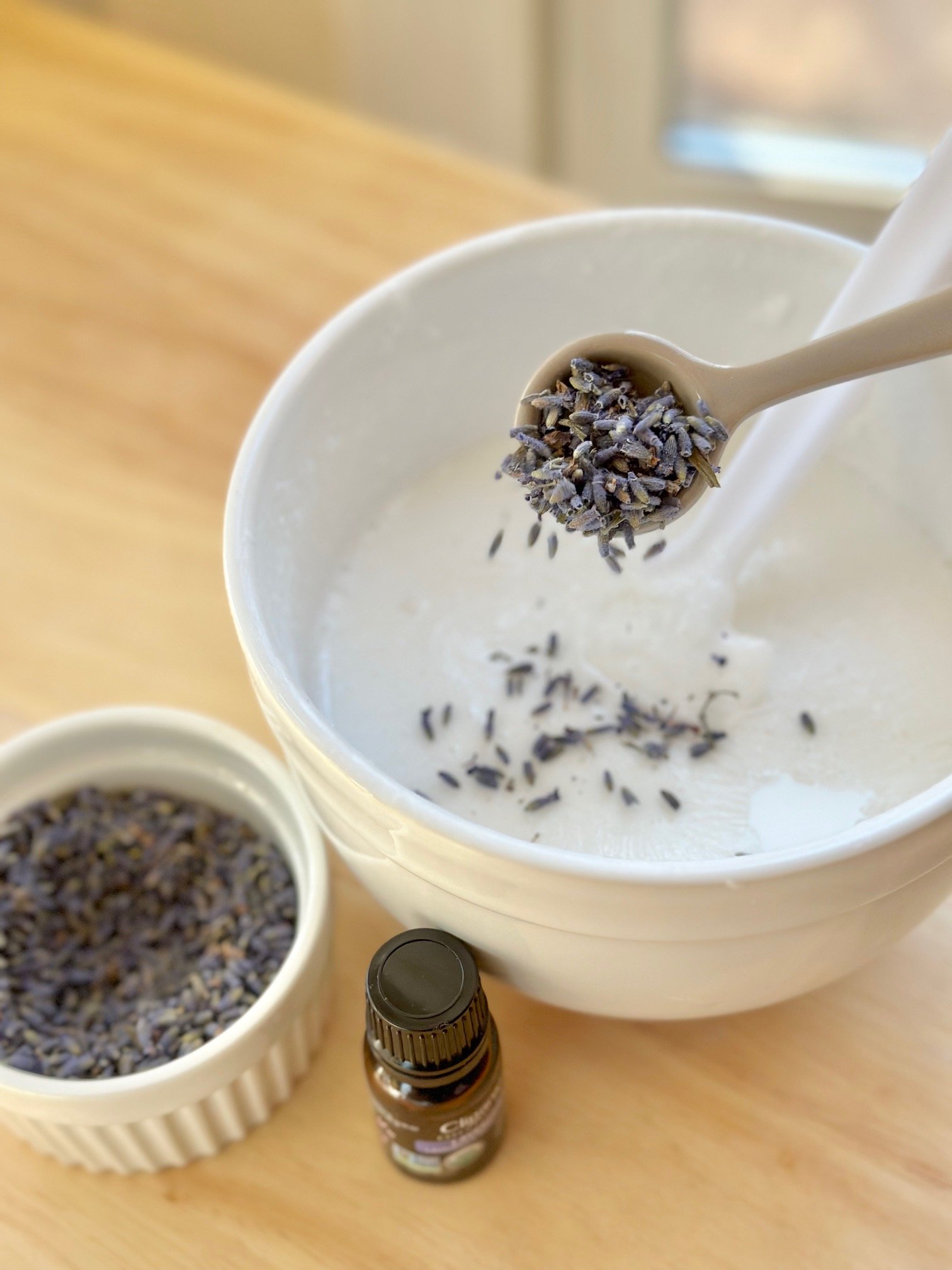 Adding lavender buds to the melted soap.