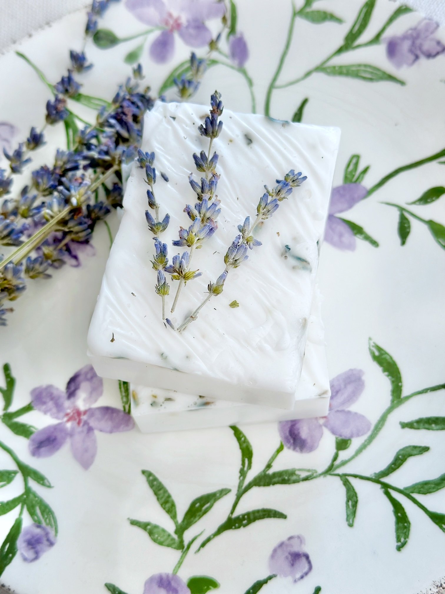 Soap on a dish with some lavender next to it. 