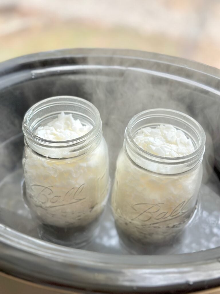 2 ball jars with soy chips sitting in the boiling water in the crockpot. 