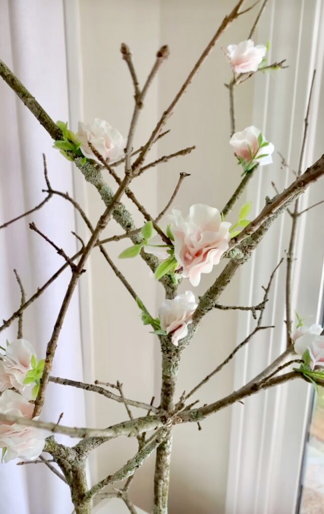 A close up of the faux cherry blossoms on the branches. 