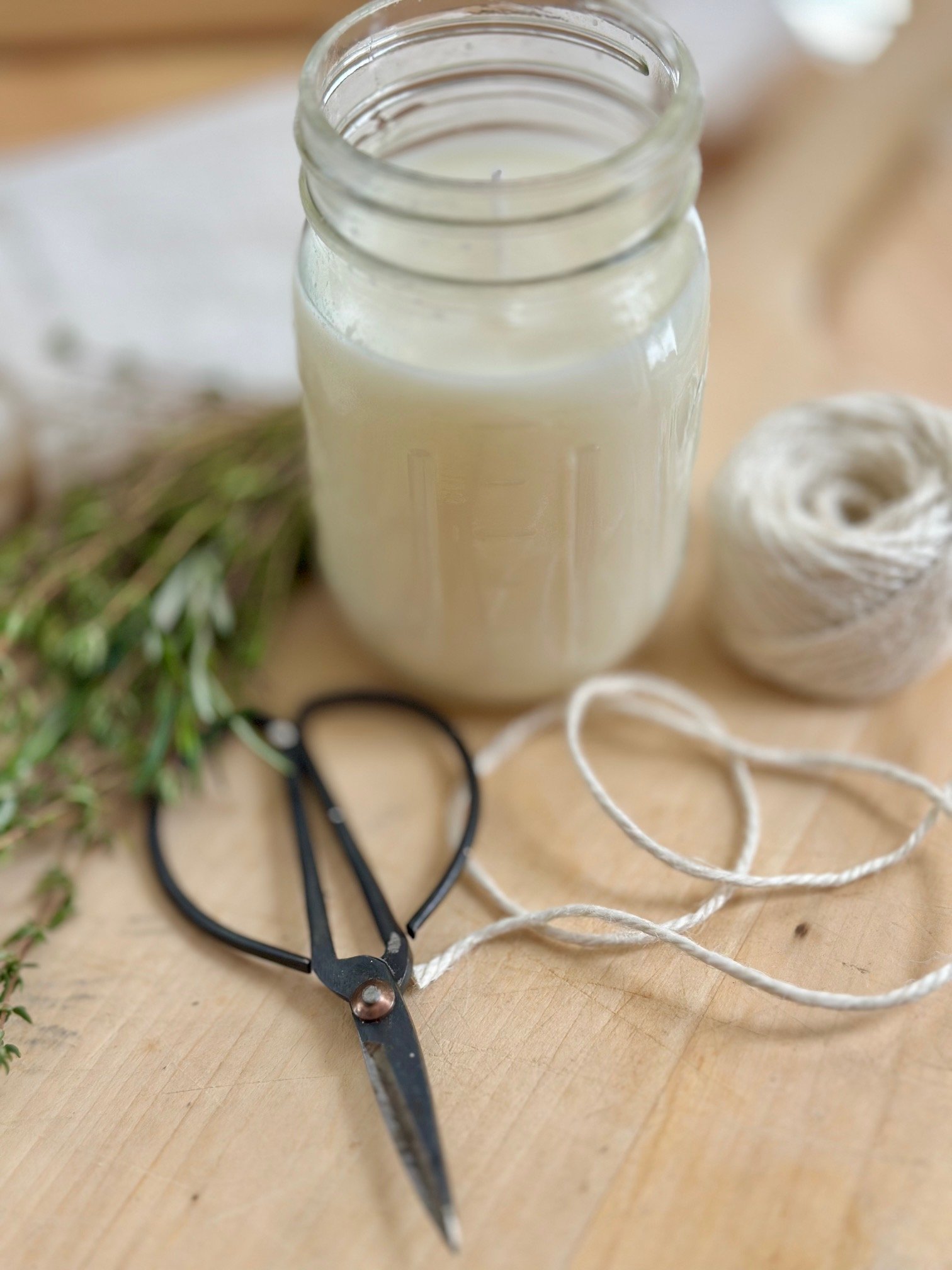 Herbs, candle, scissors, twine. 