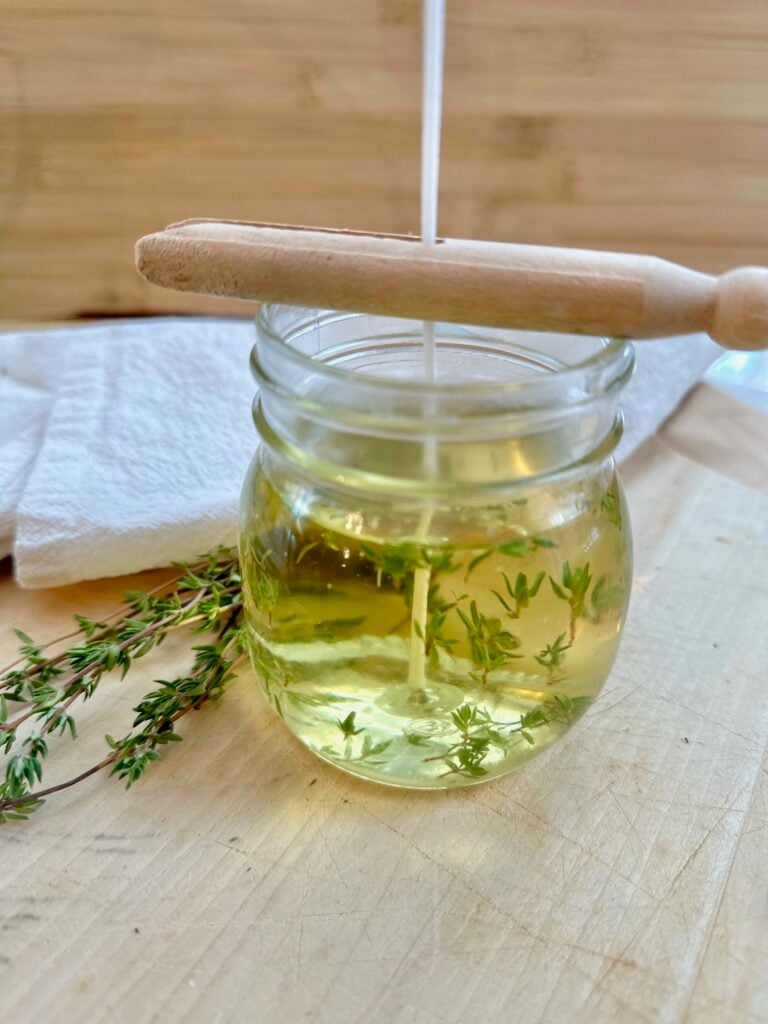 A clothespin supporting the wick. 