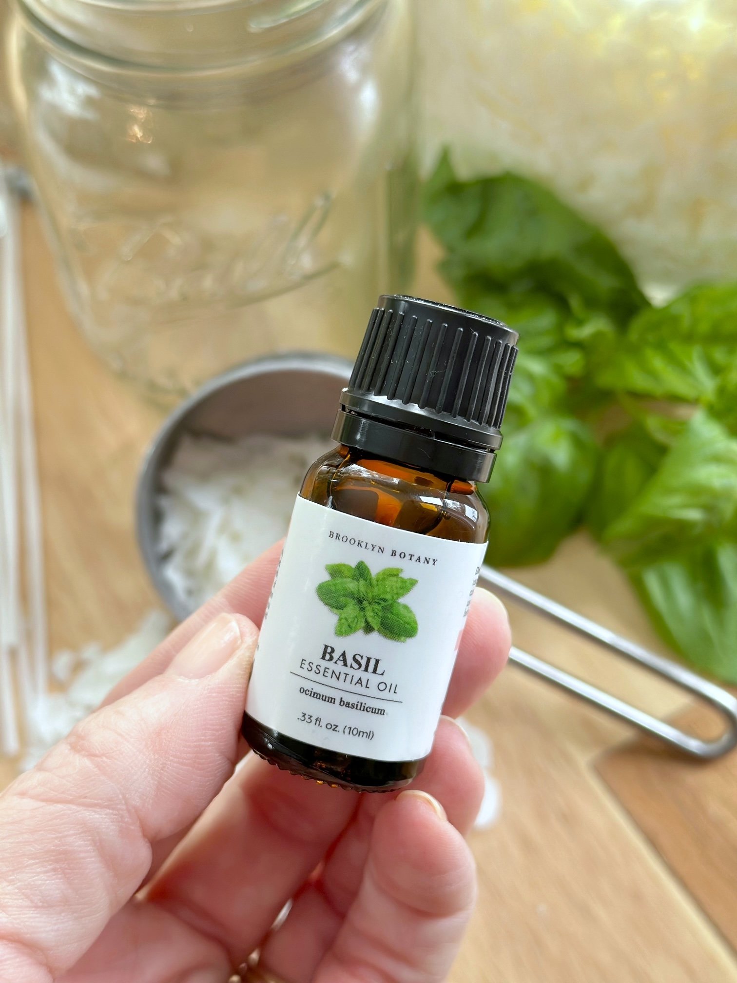 Holding a small bottle or basil extract. 