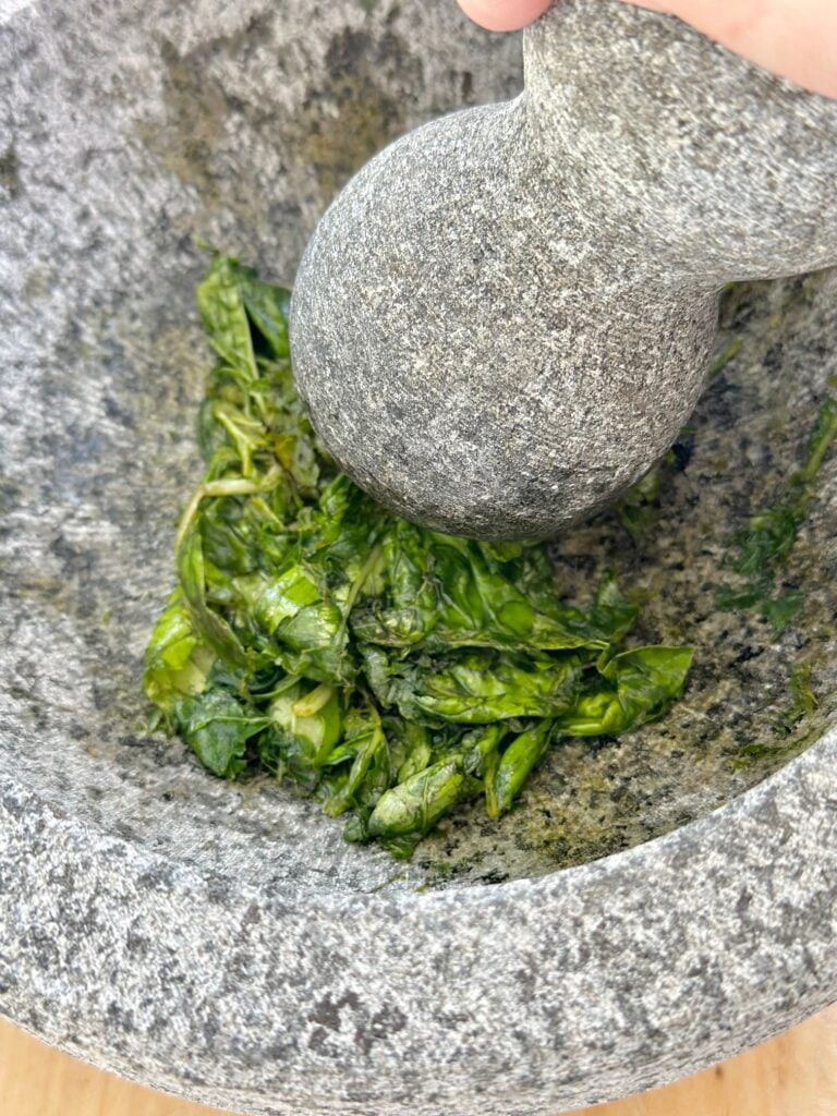 Crushing basil leaves. 