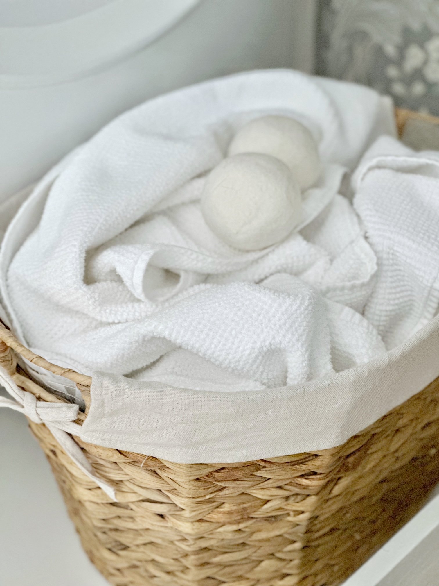 top view of laundry basket with towels and dryer balls. 