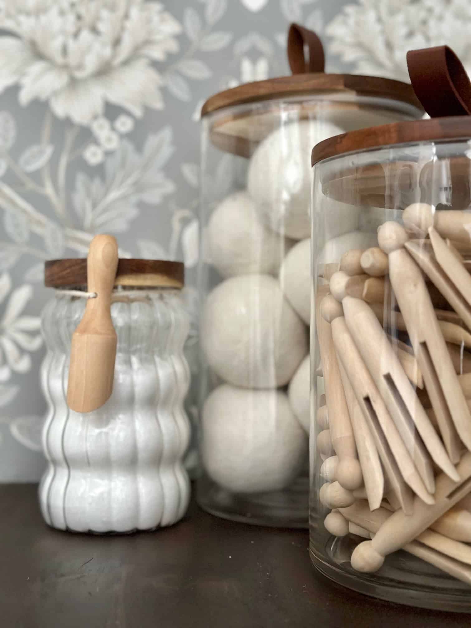 Laundry room essentials, wool dryer balls, clothes pins, stain remover and laundry scent boost.