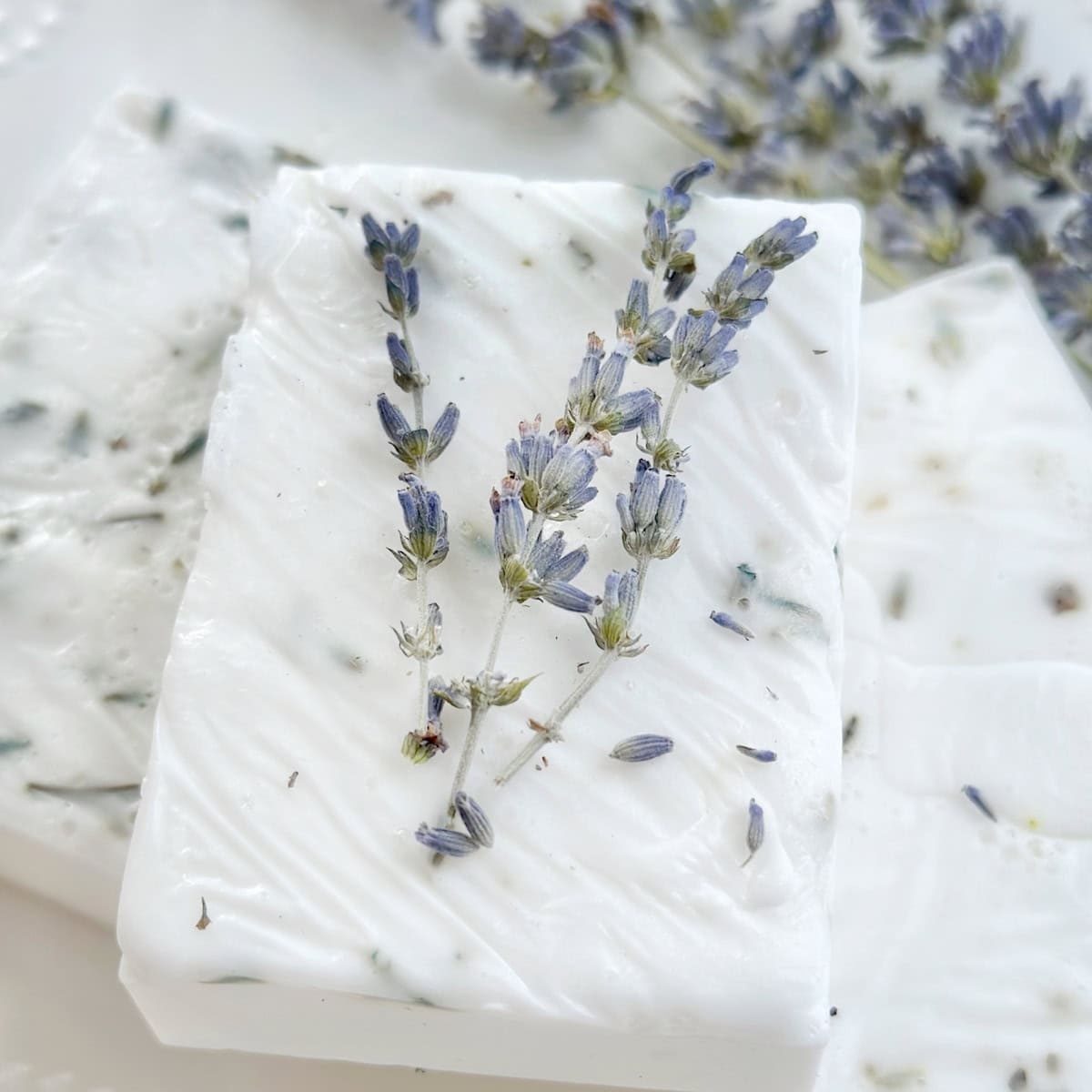 Stack of soaps with lavender sprig.