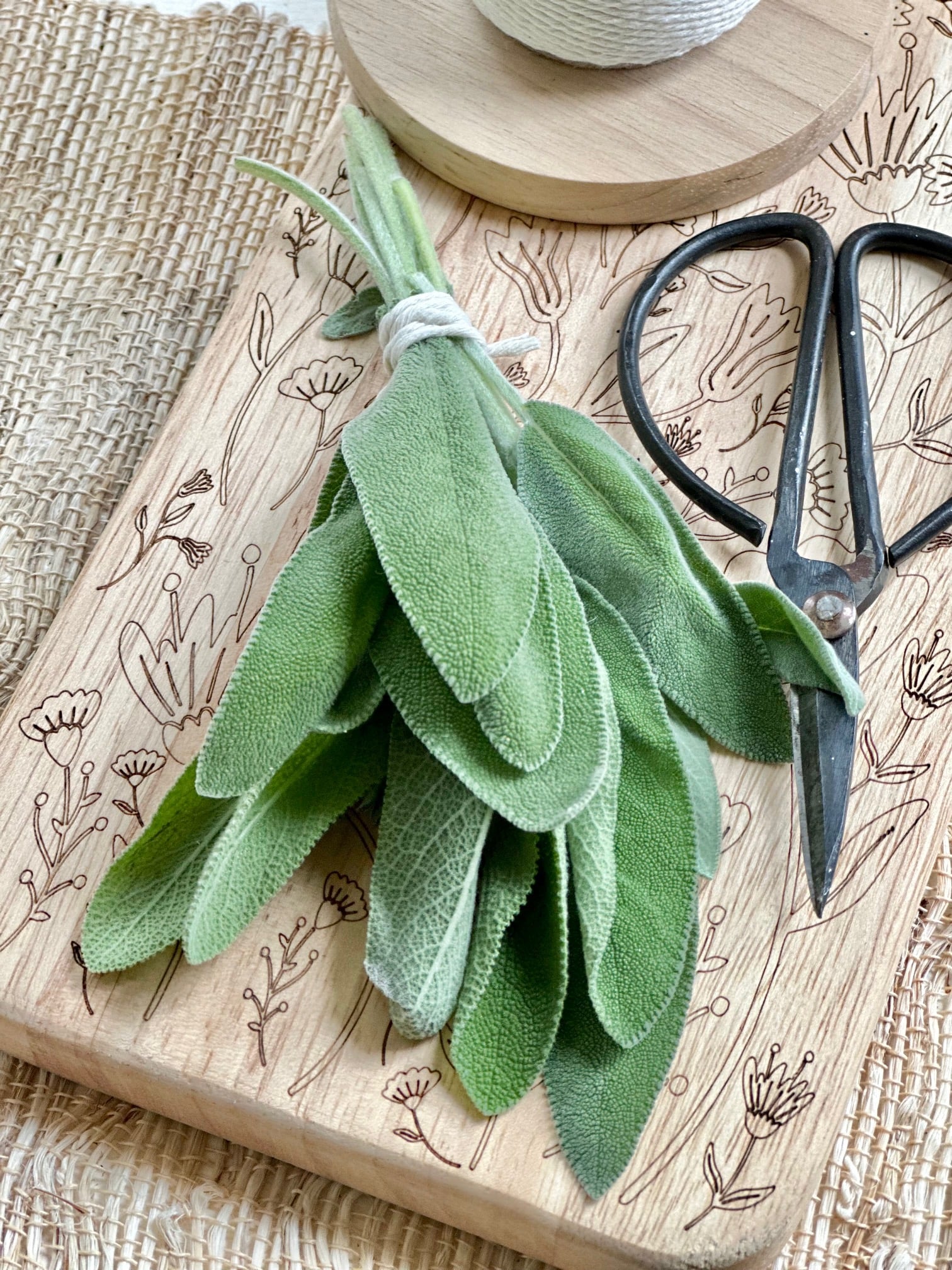 Sage in a bundle on a cutting board.