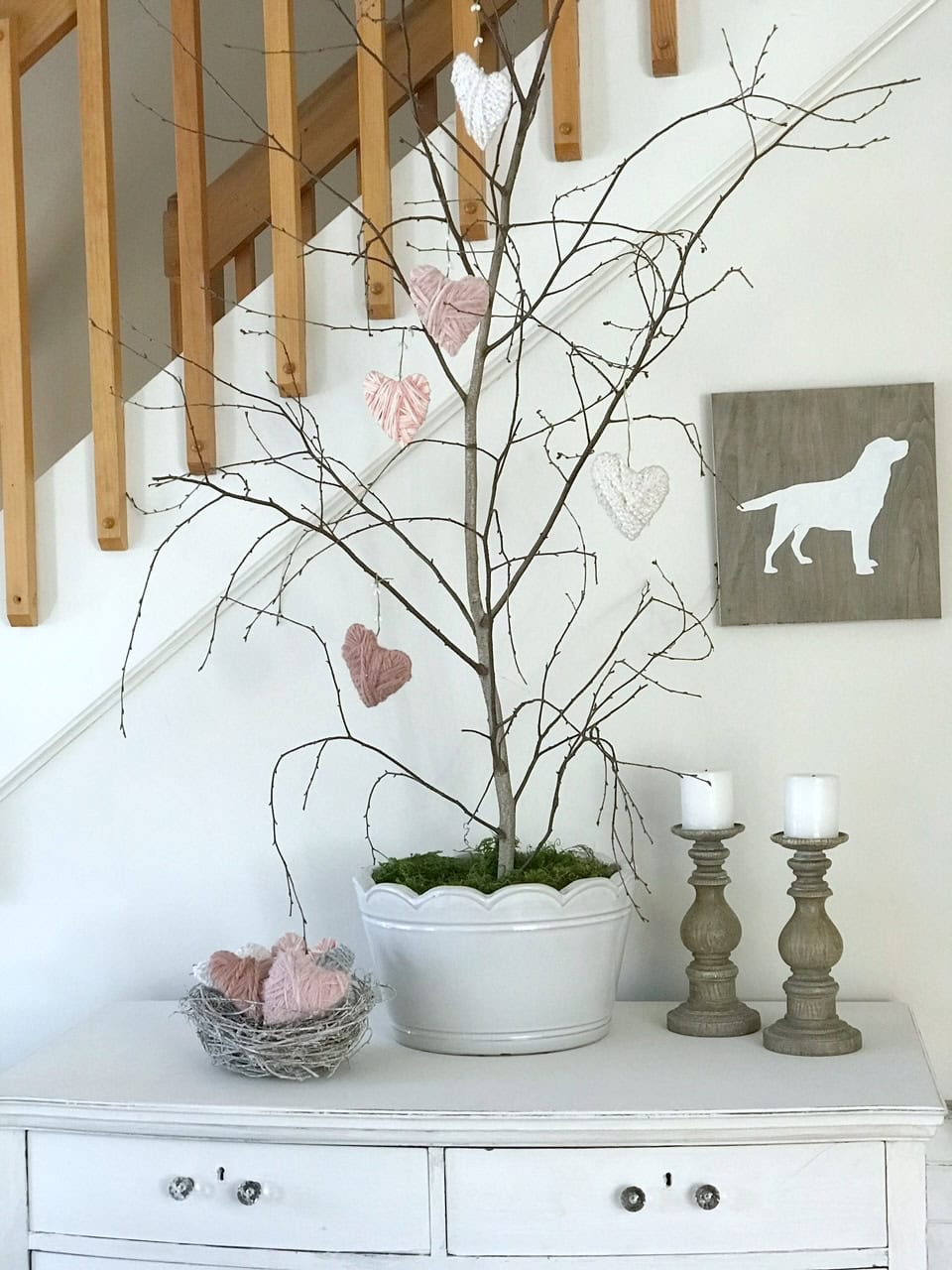 Branches with moss covering the foam in the pot.