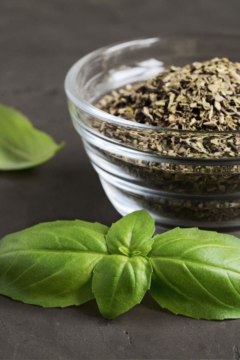 Dried basil in a glass dish. 