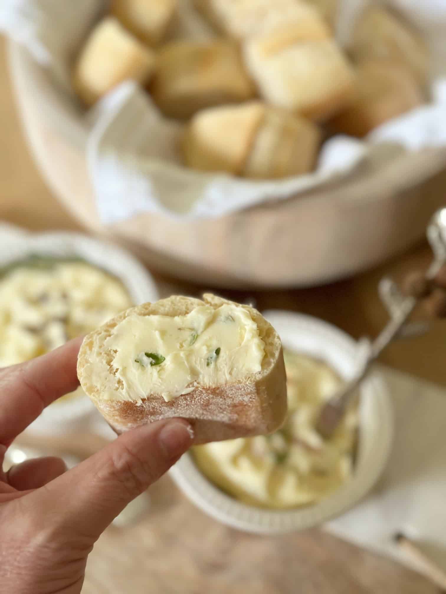 Me holding a piece of bread with herb butter on it. 