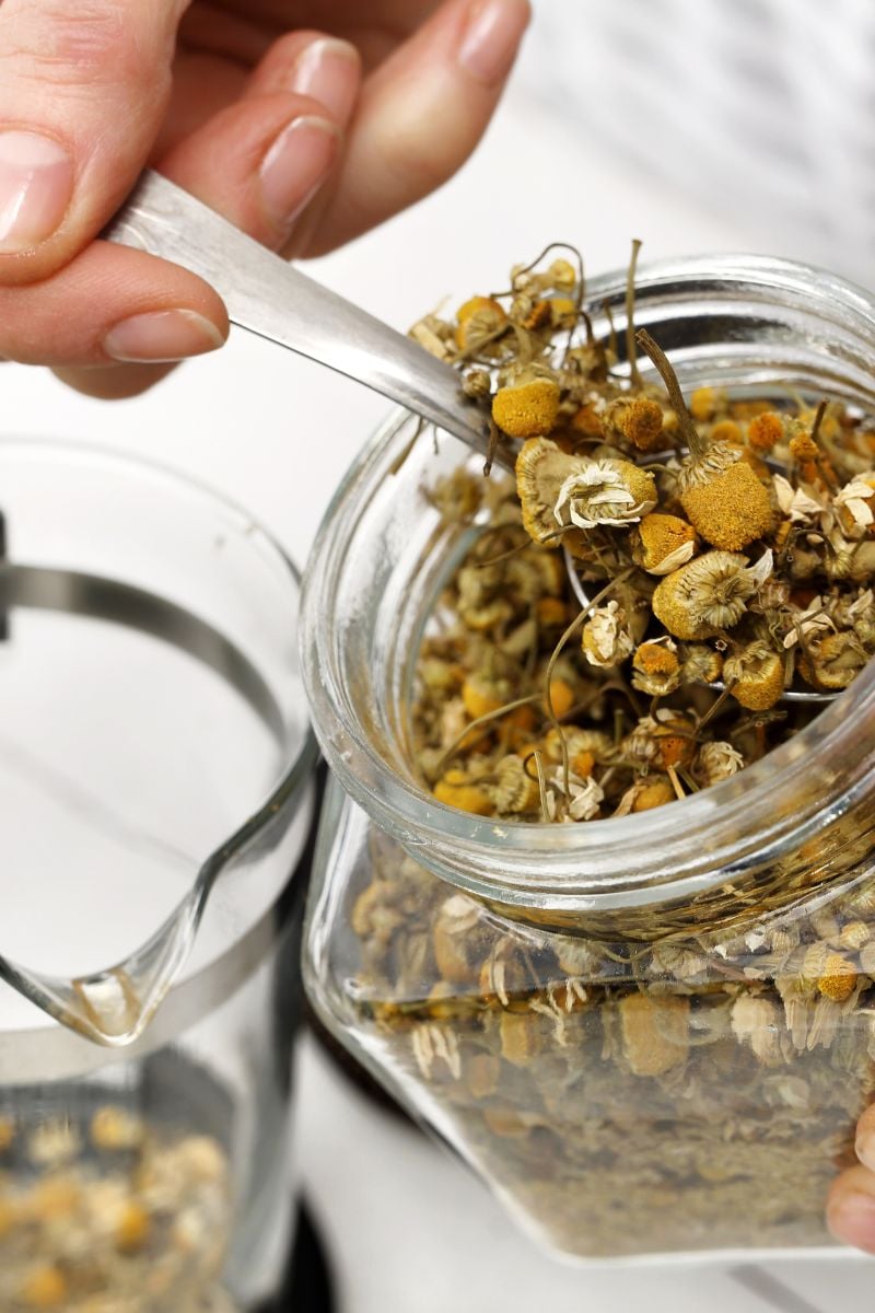 A jar of dried herbs to make tea. 