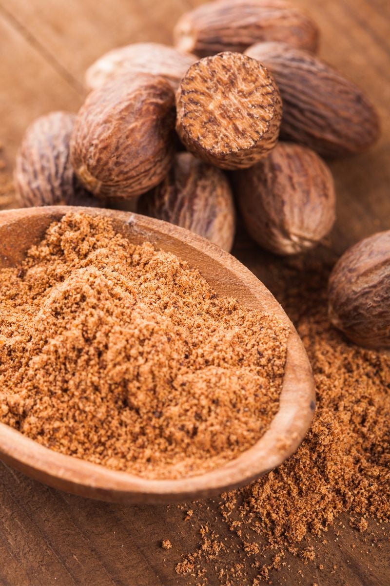 Nutmeg, grounded in a wood bowl. 