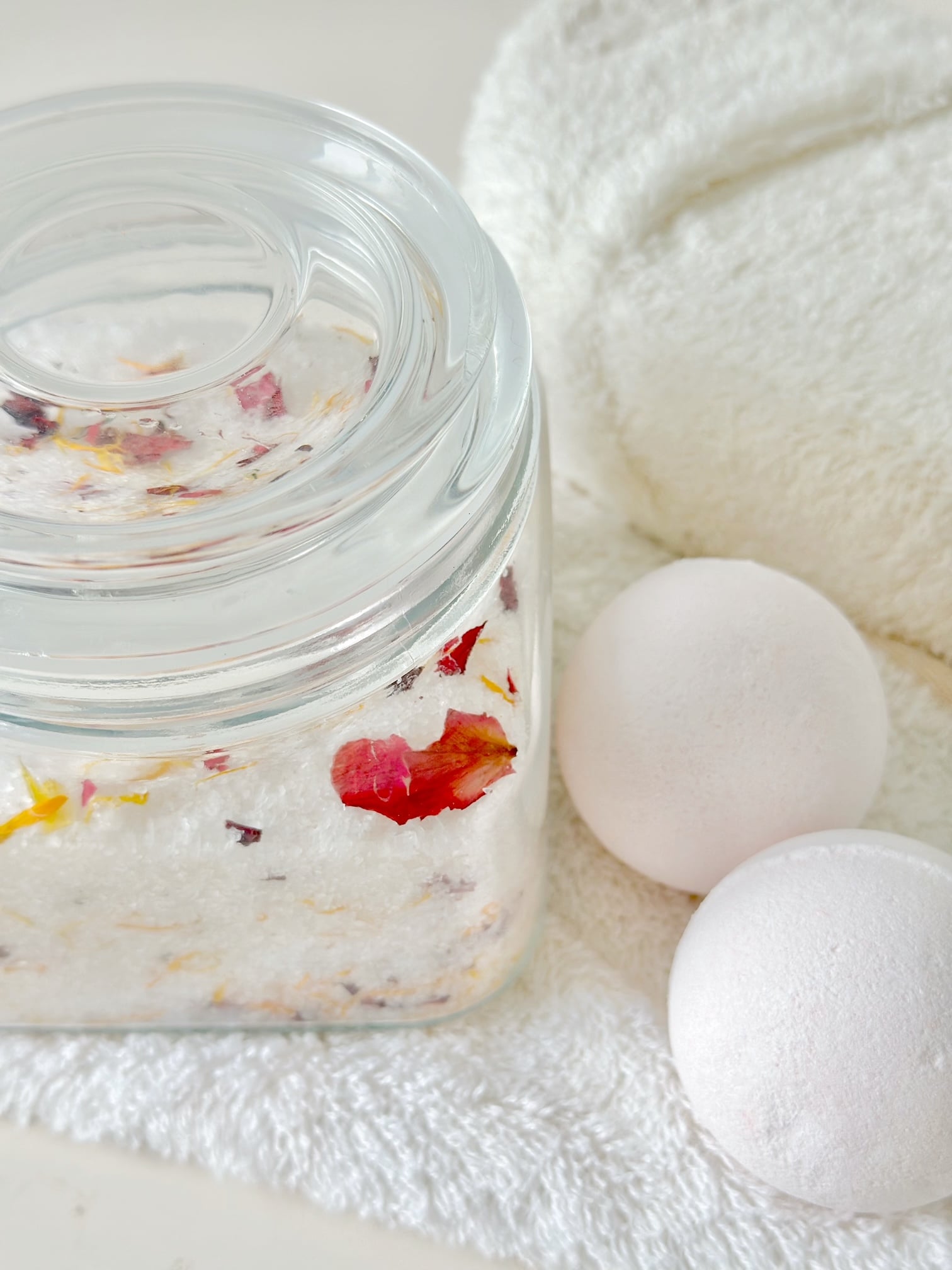 bath salts with bath balls and towels.