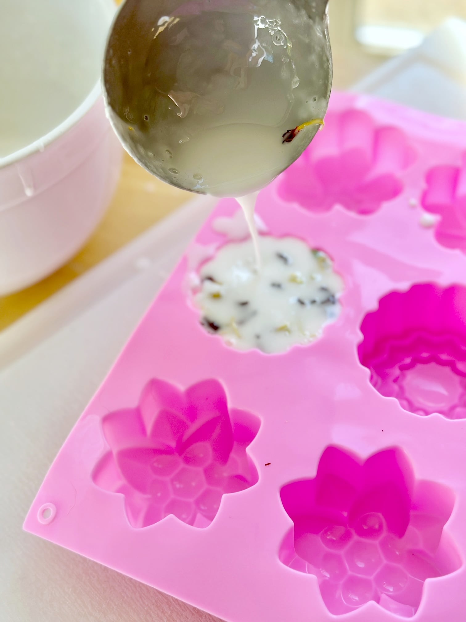 pouring the soap mixture into silicone molds. 