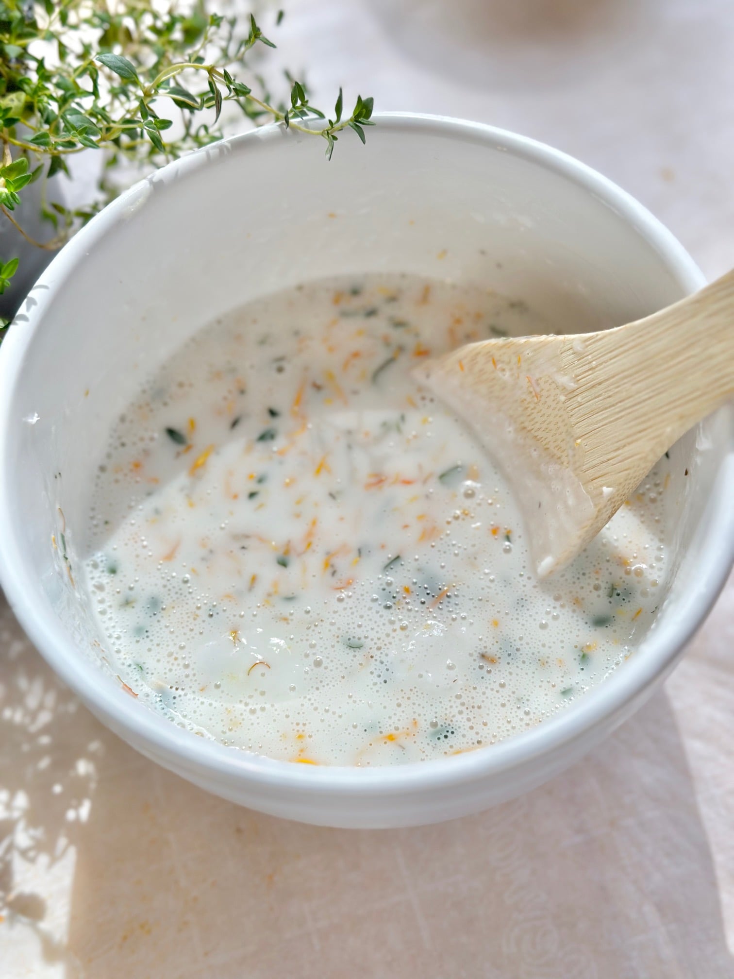 The calendula and thyme mixed in with the melted soap base. 