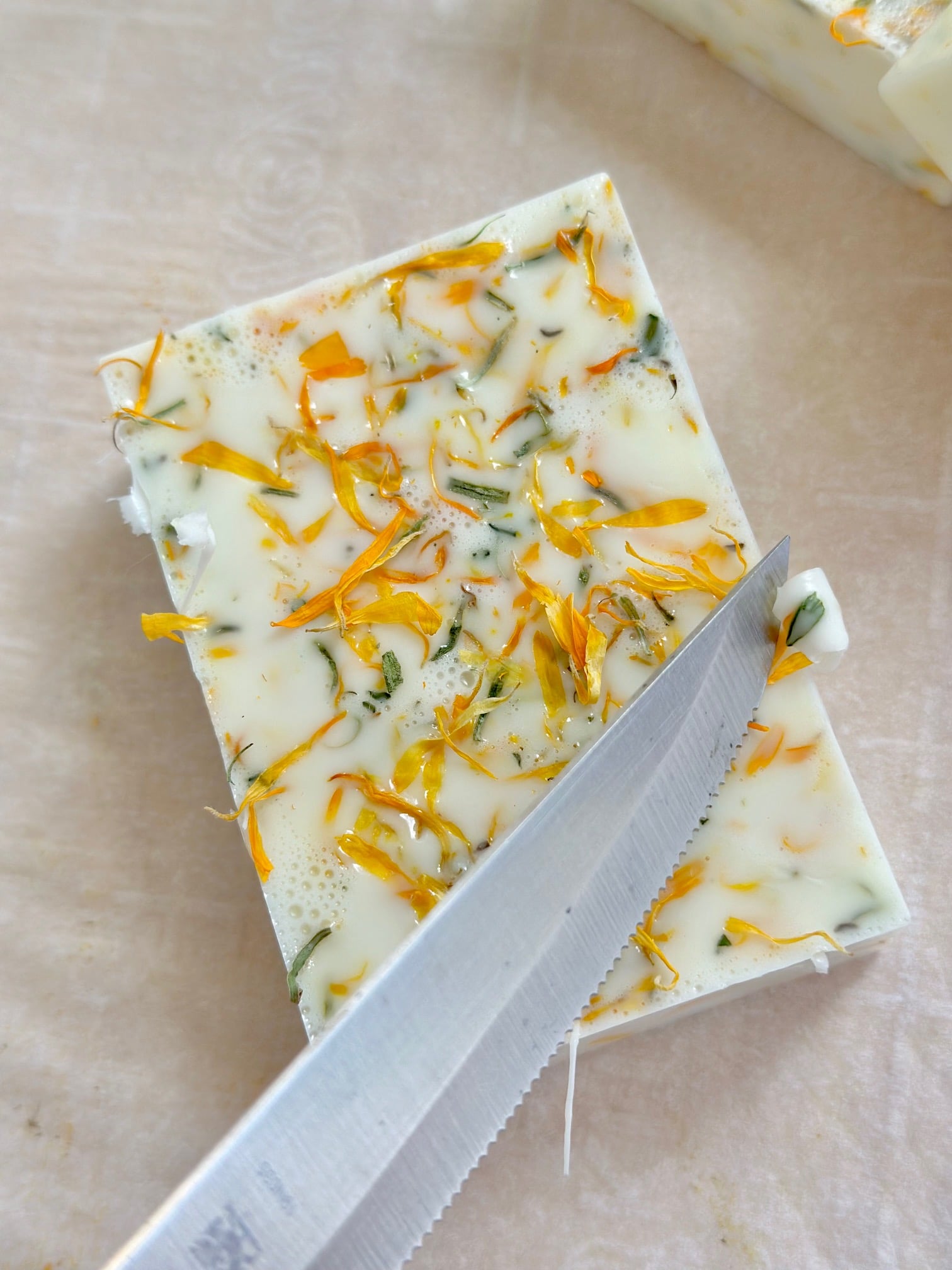 cutting the edges of the soap with a knife.