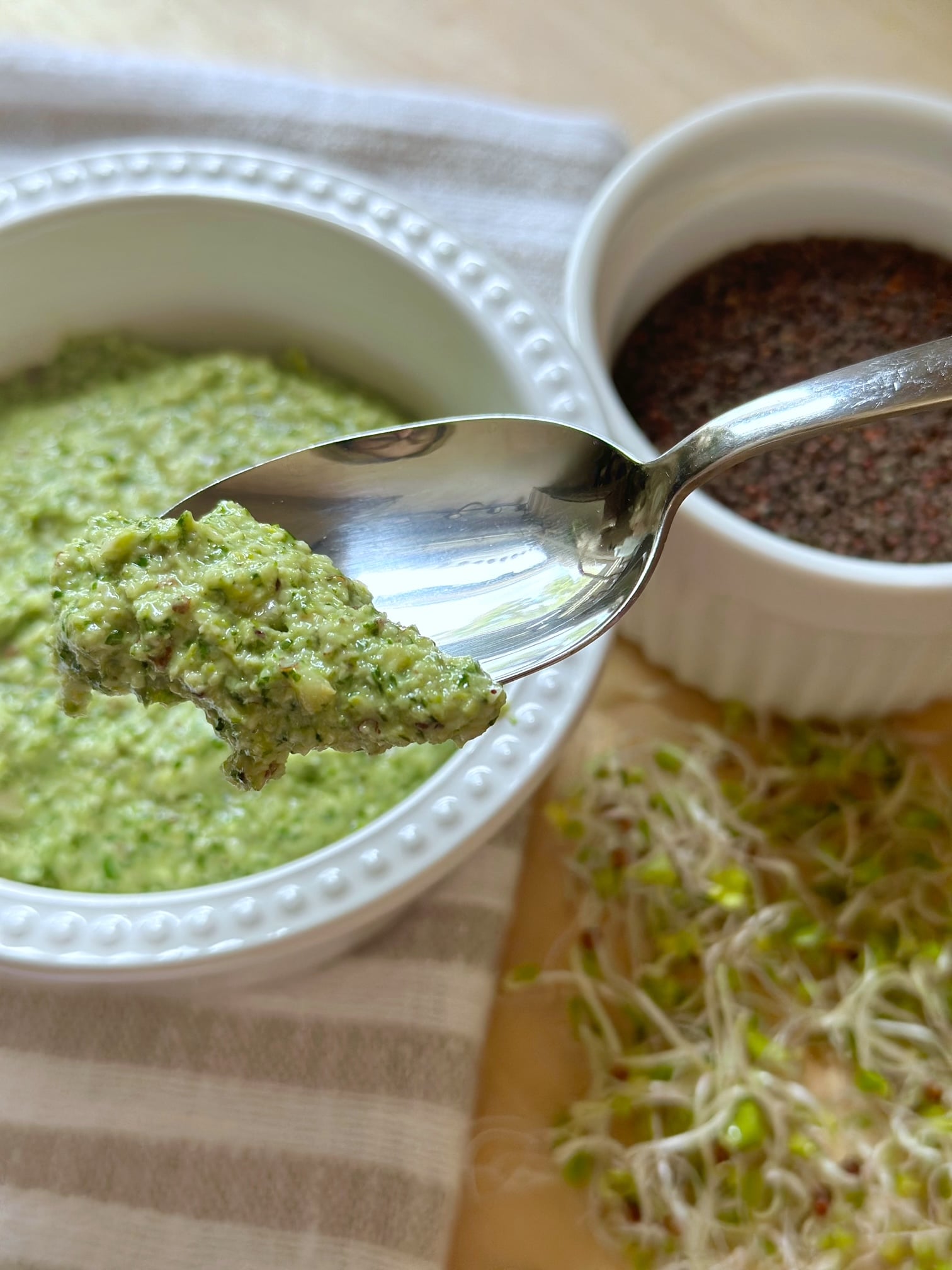 This Lemony Basil Pesto Made with Broccoli Sprouts in a spoon. 