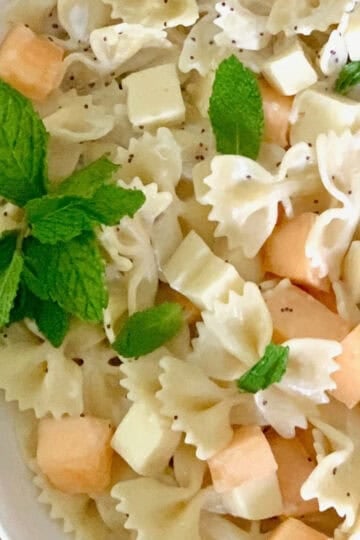 Mint cantaloupe pasta salad in a large bowl. This is a bright pasta salad.