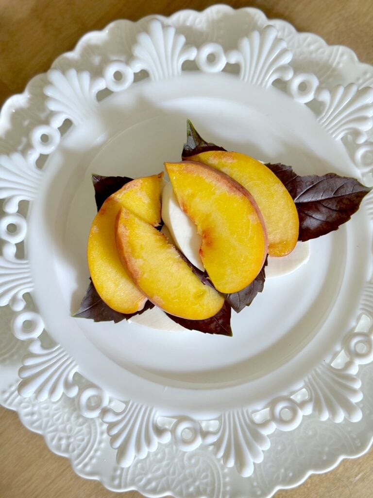 the slice peaches added to the top pf the cheese and basil. 