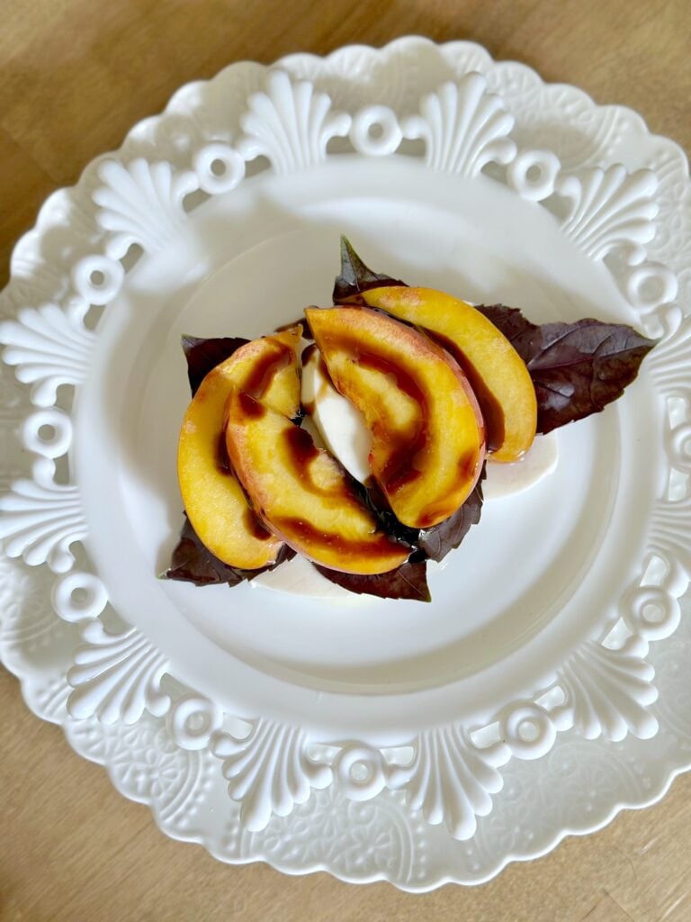 The caprese salad with olive oil and balsamic glaze  drizzled on top. 