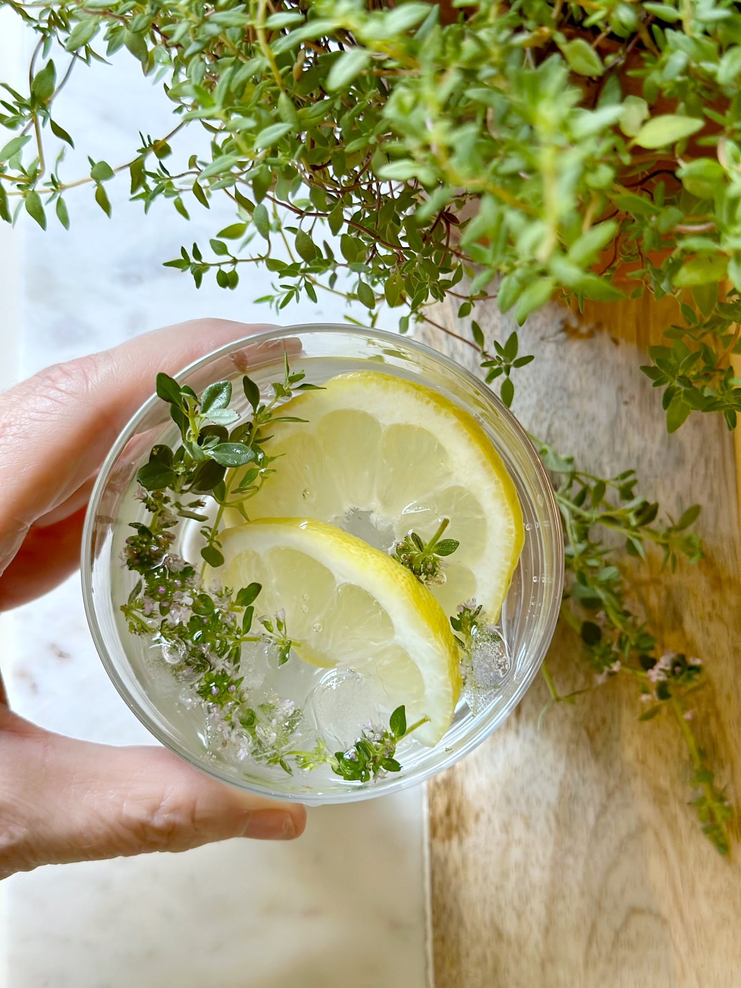 top view of a glass of lemon thyme water.