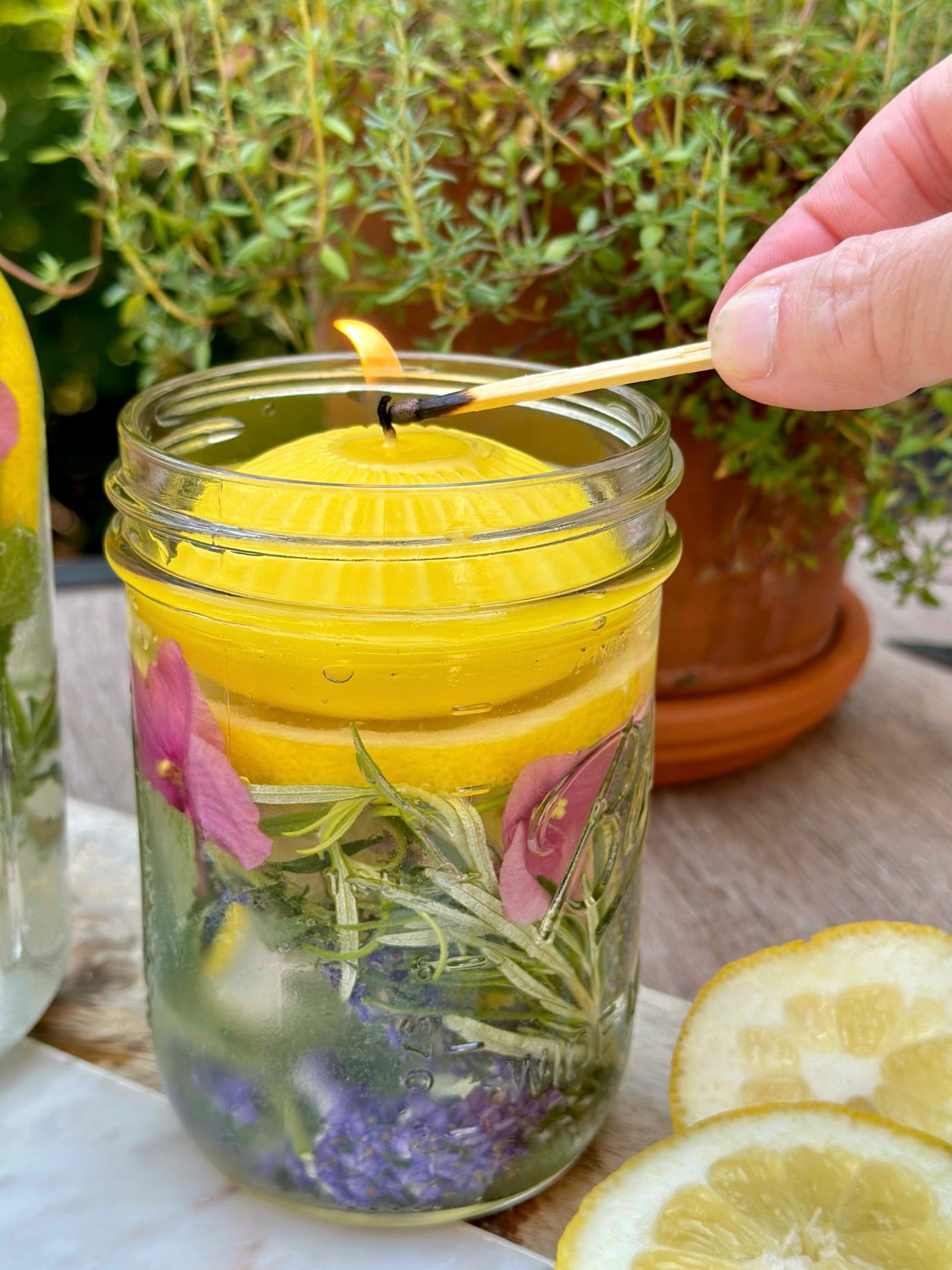 lighting the citronella candle with a match.