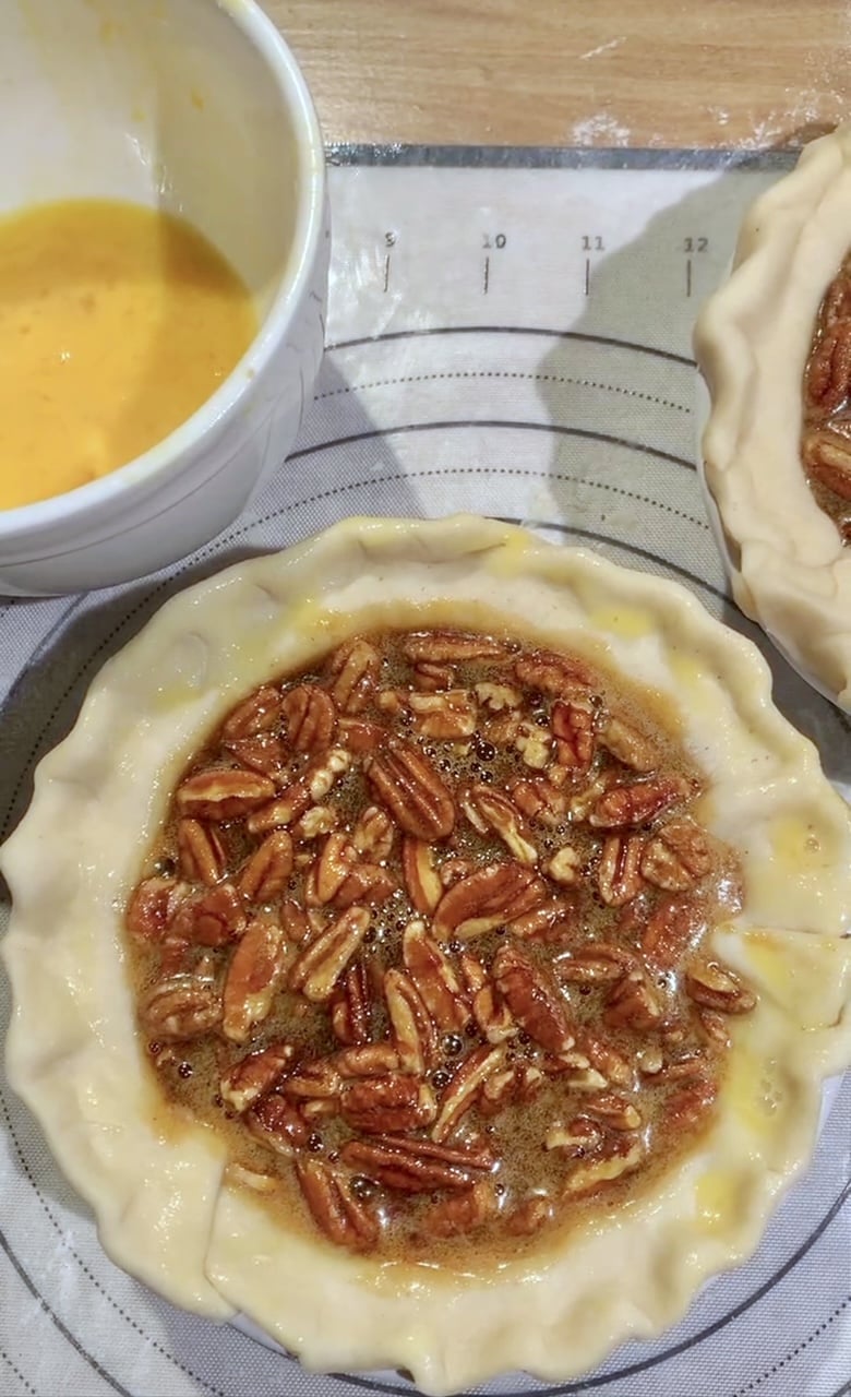 A pecan pie that is ready to go in the oven. 