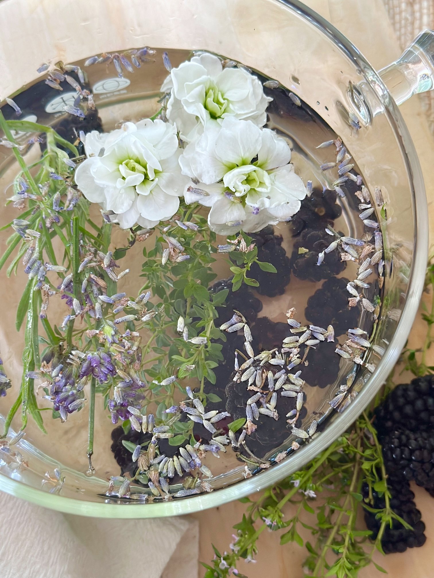 berry bliss summer simmer pot recipe in a clear glass cooking pot. 