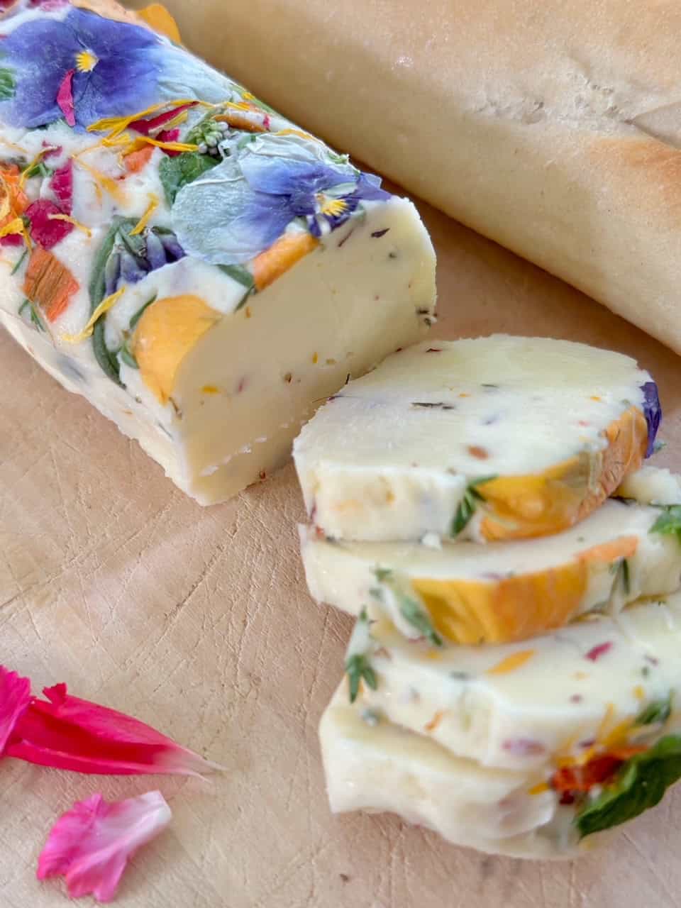 Sliced herb butter with edible flowers. 