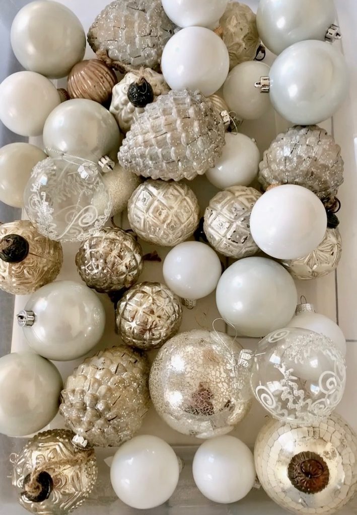 A box full of neutral assorted ornaments.