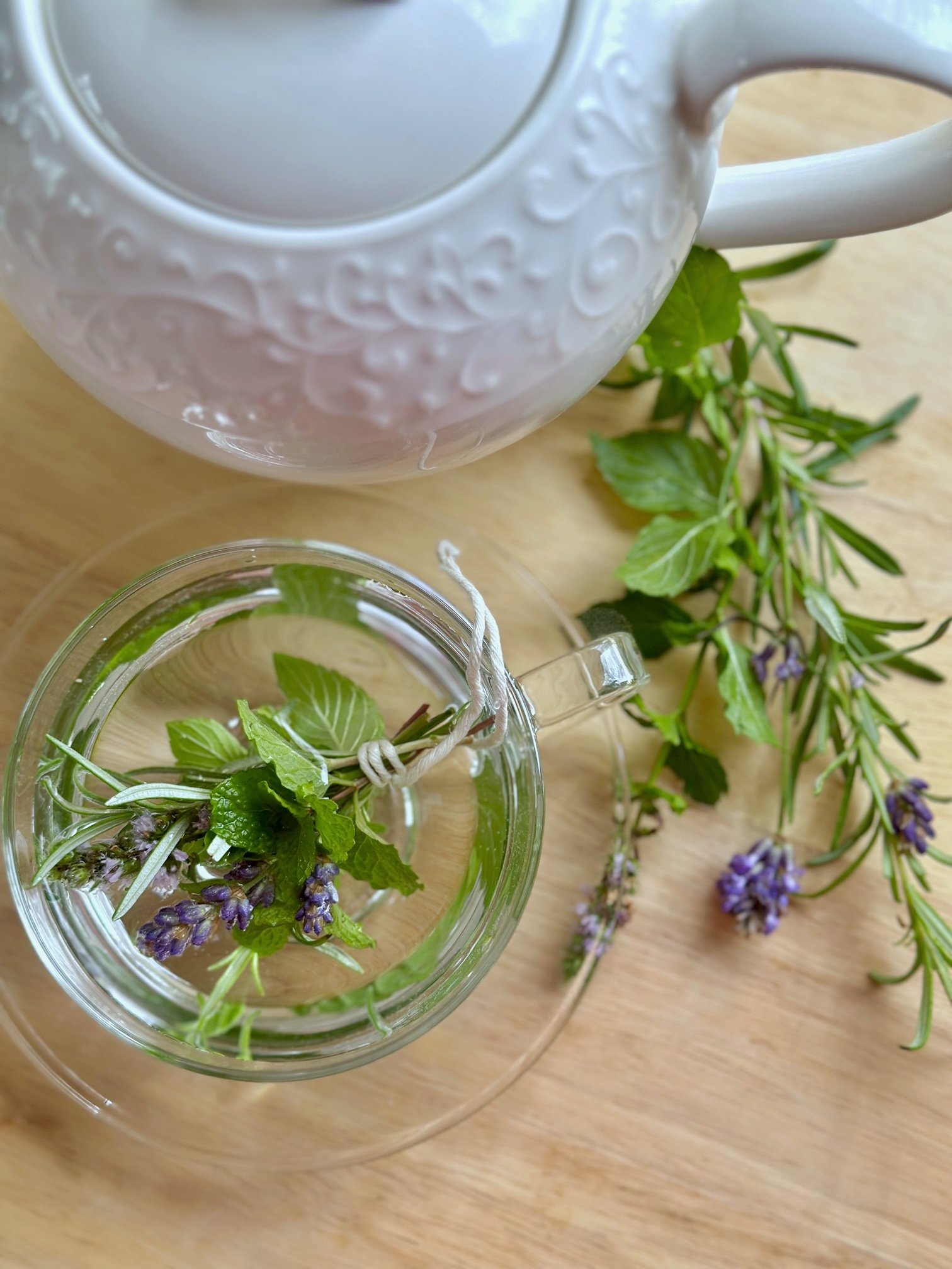 Fresh herb tea with a tea pot.