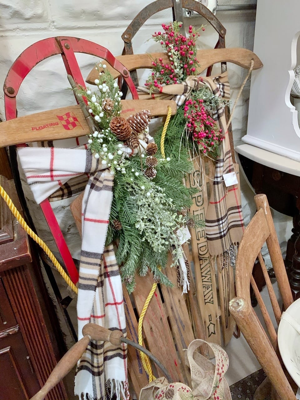 Sleds at my vintage booth for sale.