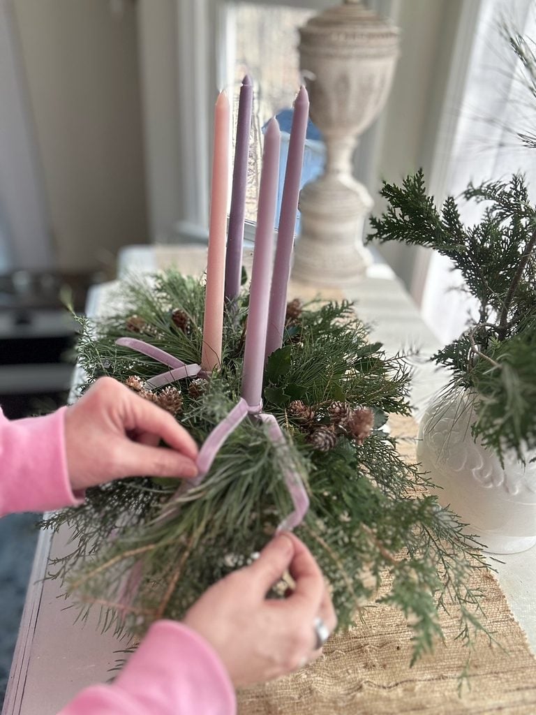 Draping the velvet ribbon on through the greens.